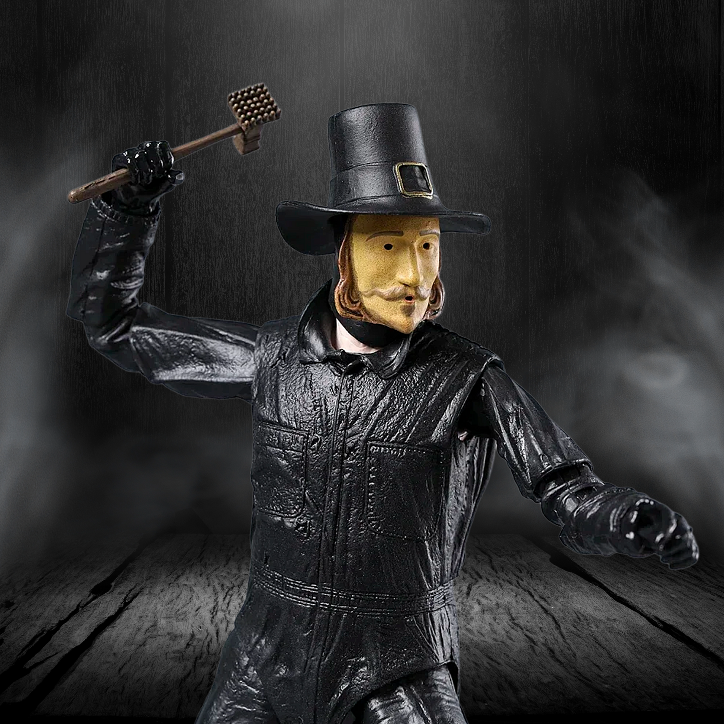 Figurine of a man in historical attire holding a key against a dark background