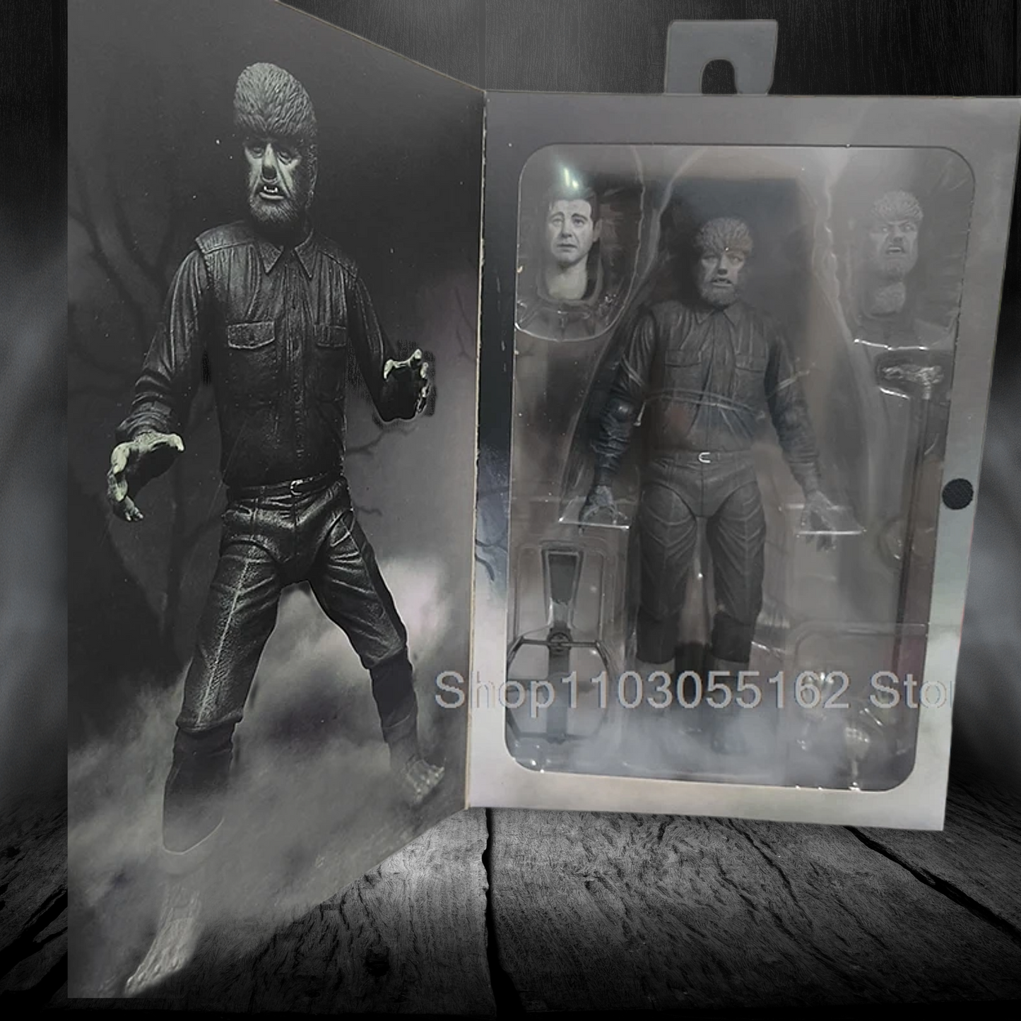 Action figure of a character in a dark outfit with a gun, next to its packaging on a wooden surface.