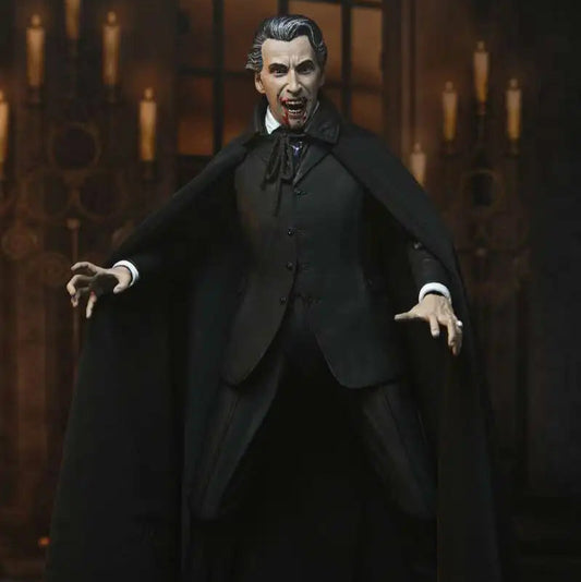 Action figure of a character in a dark suit and cape against a gothic-style background with candles.