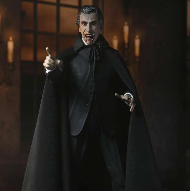 Action figure of a character in a dark cloak and suit, pointing forward, with a gothic interior background.