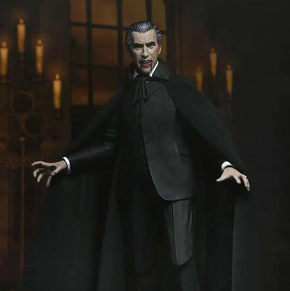 Action figure of a character in a black cape and suit with gothic architecture in the background