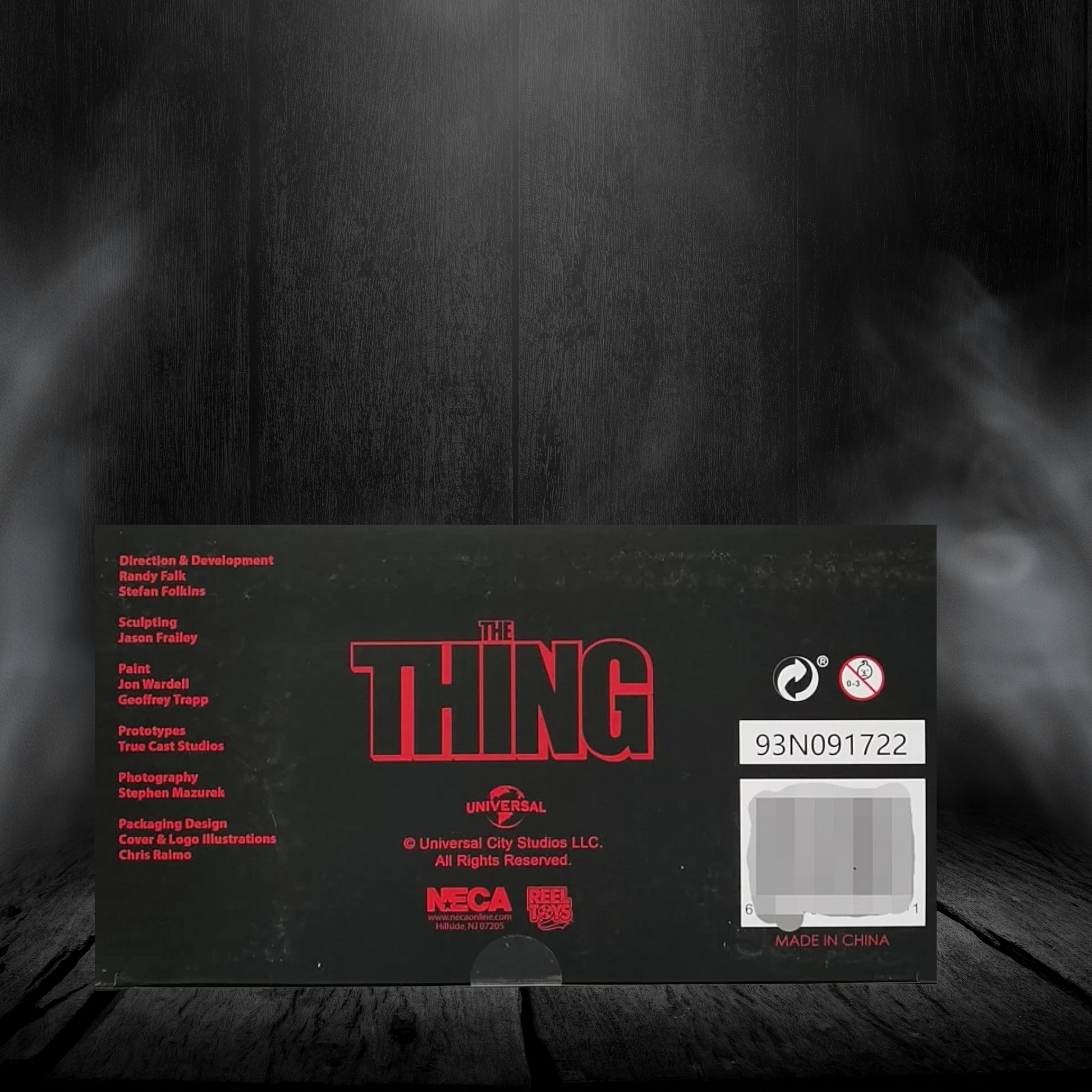Black box with red text and branding on a dark background